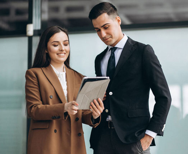 Two professionals reviewing work information on a tablet